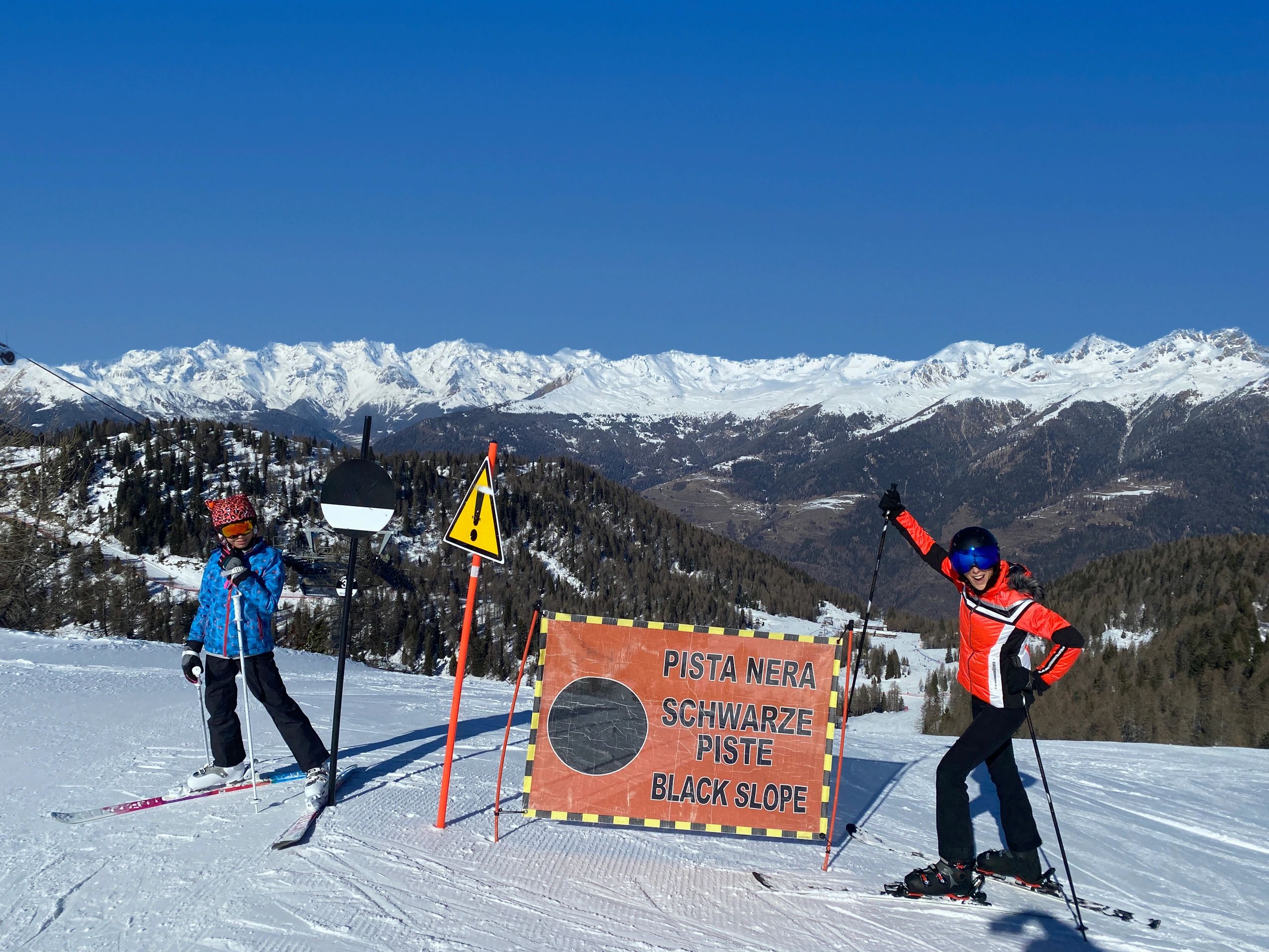 Instructor and student preparing for a ski run