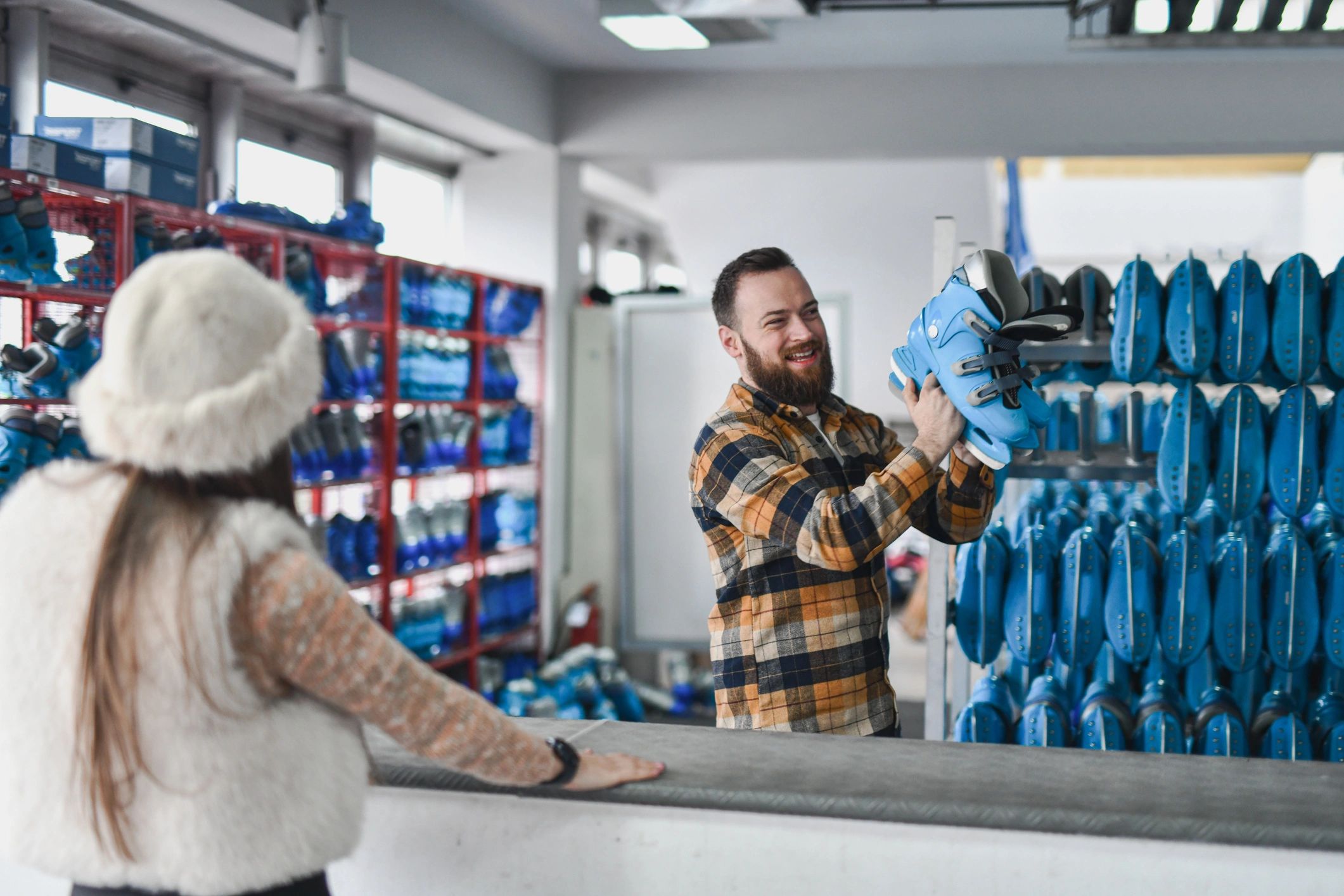 Shop staff assisting a customer at a counter