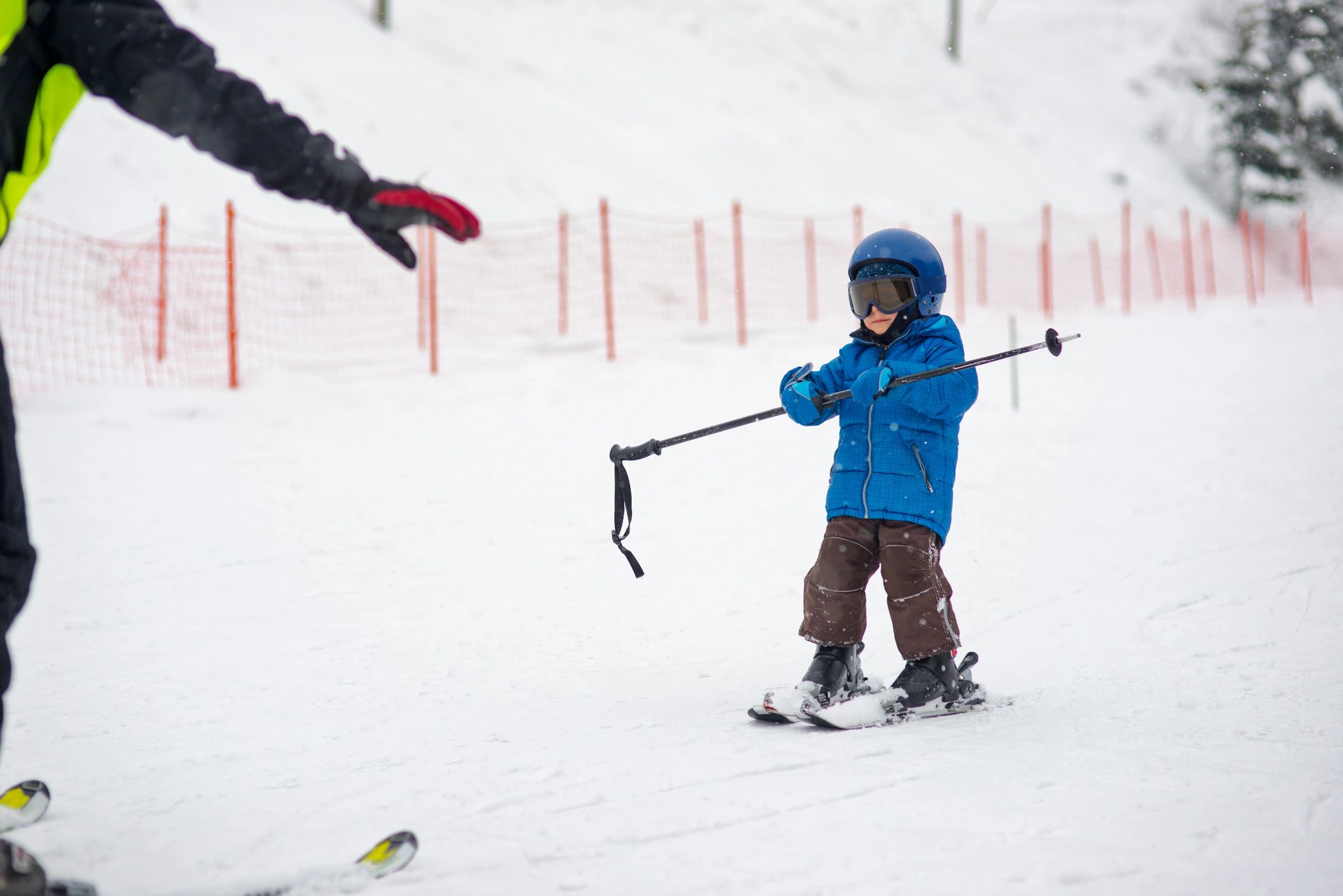 Child learning to ski on a gentle slope