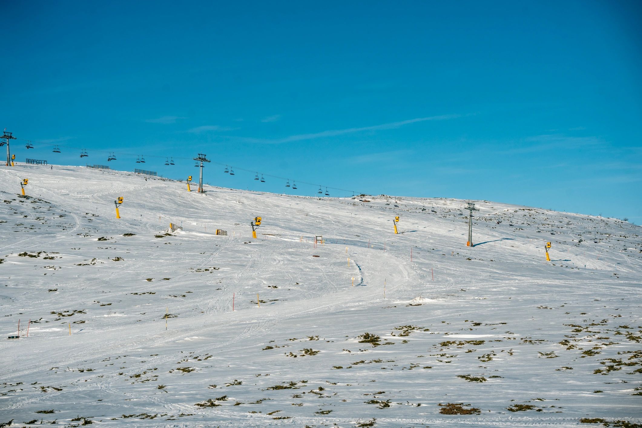 Chairlifts over a snowy ski slope