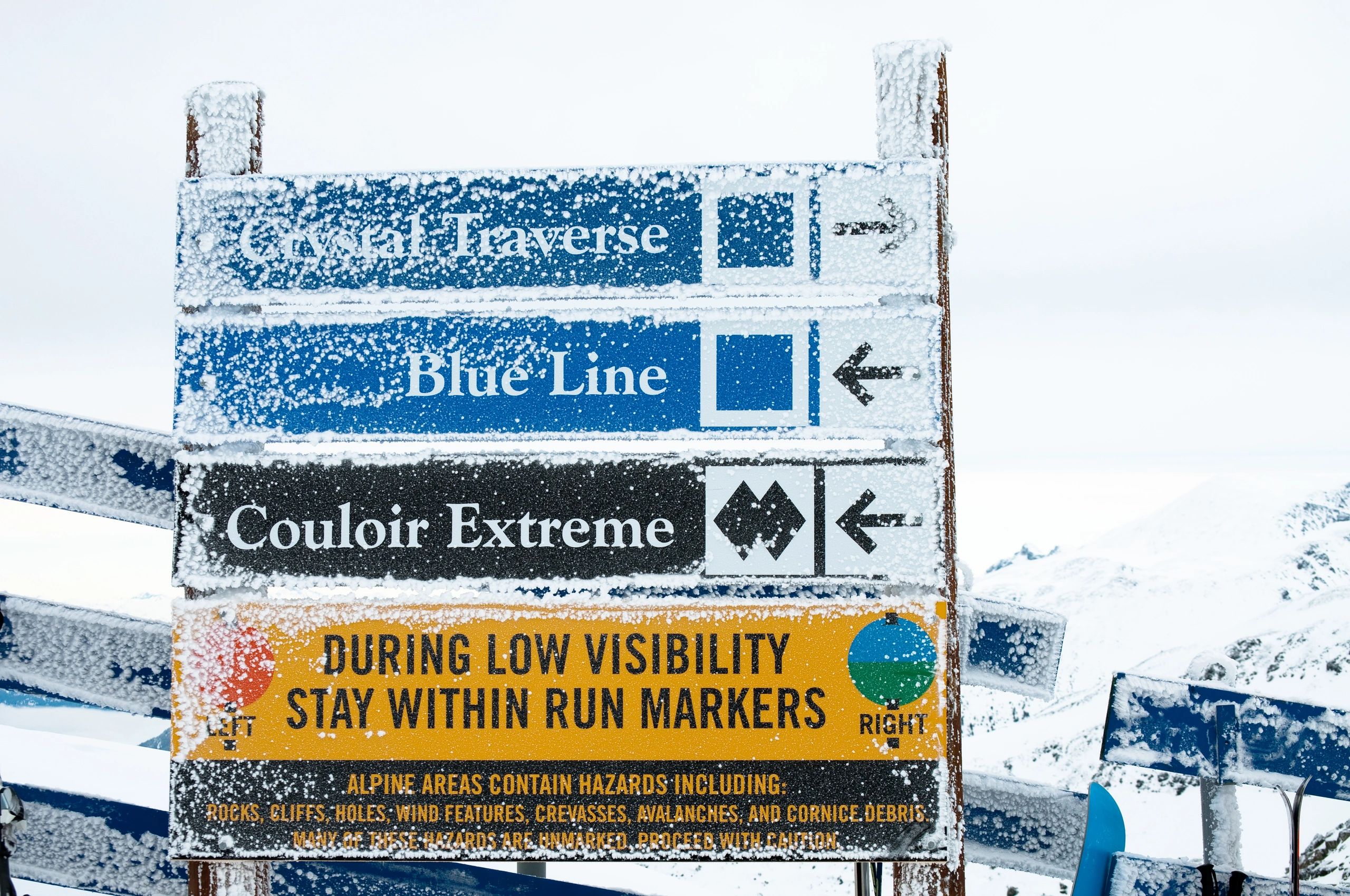 Ski trail rating signs with blue and black markers